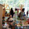 Families monitor children as they play in the children's room.