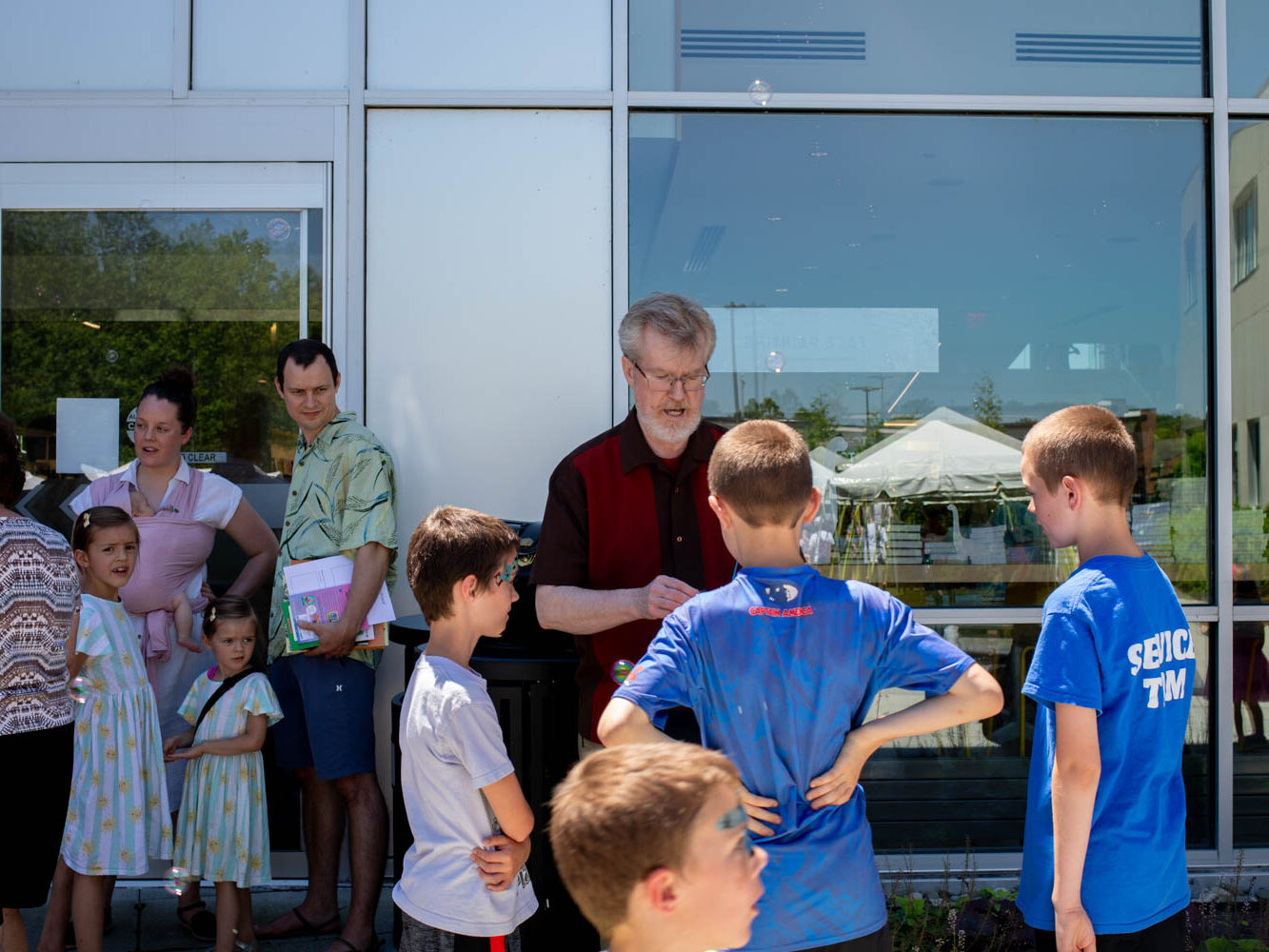 Author and children speak while looking at children's books.