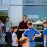 Author and children speak while looking at children's books.